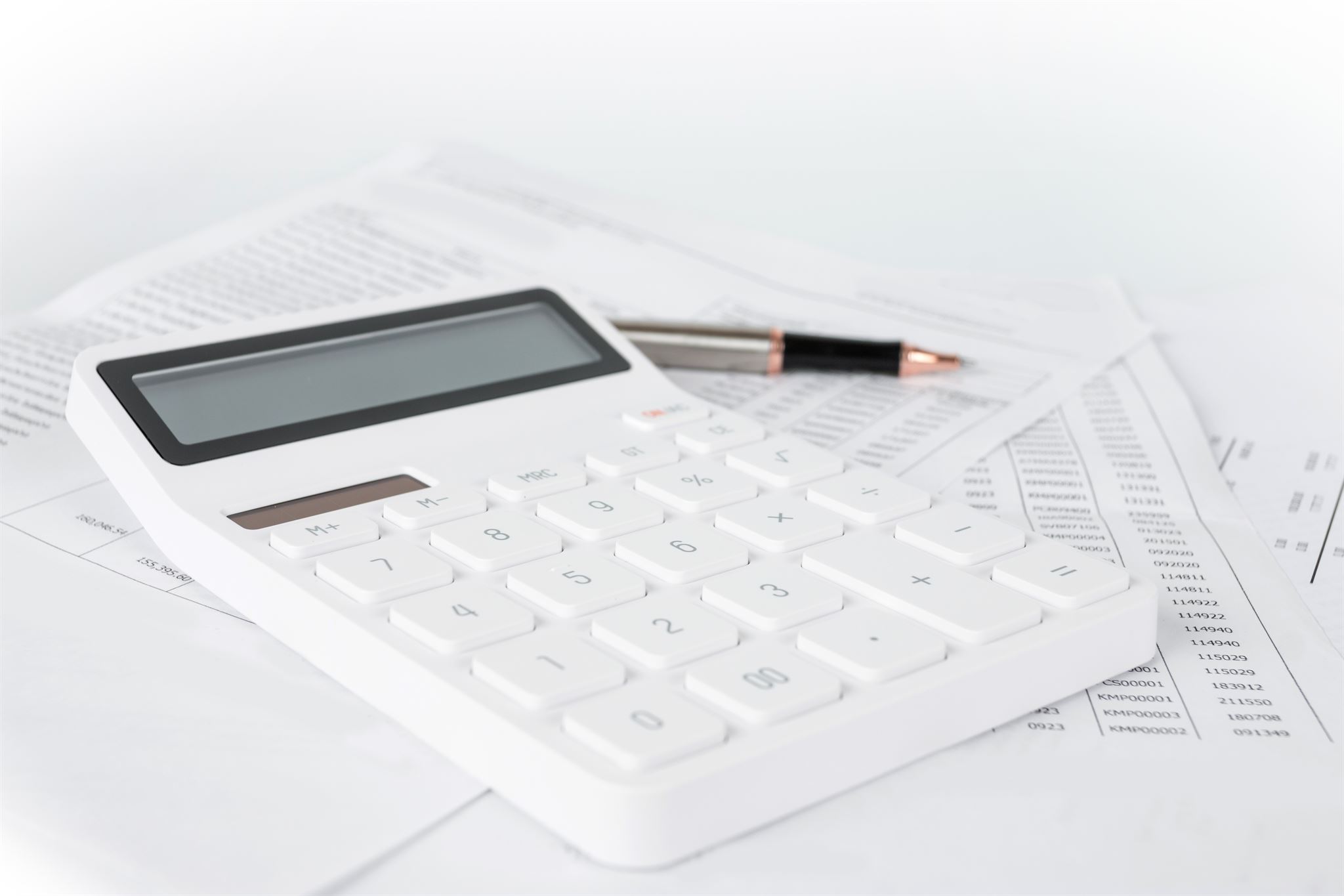 Stack of financial documents and calculator